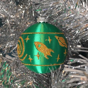 Retro Rocket in Space Round Christmas Bulb Ornament Vintage-Style Shiny Plastic Ball Glitter Galaxy Stars Mid-Century Modern Holiday Decor