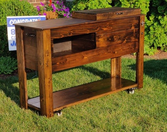 Beautiful, hand built, rustic jacobean cedar cooler with bar area, storage area, storage shelf and casters.