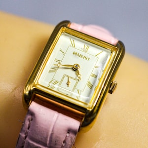Merit , gold tone with pink bracelet , womens watch