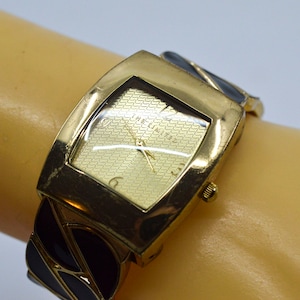 Gold and black tone womens, cuff watch