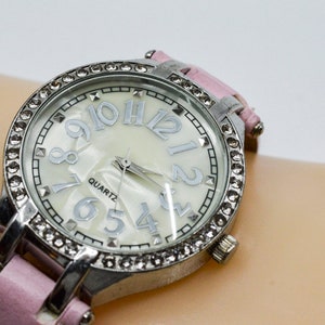Silver tone with crystals and mop dial womens fashion watch