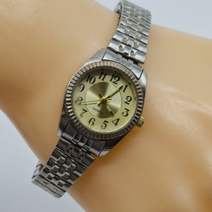 Silver tone with gold dial and stretch bracelet womens watch
