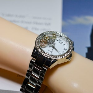 Lovely stainless steel with charms in the dial womens fashion watch