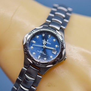 Peogeot , steel tone with blue dial, quartz wrist watch