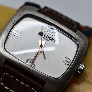 Lucky Braand , ssteel tone, with white bracelet, watch