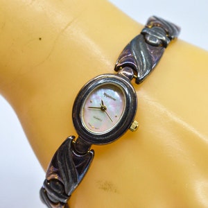 Dark , silver tone with mop dial, womens fashion watch