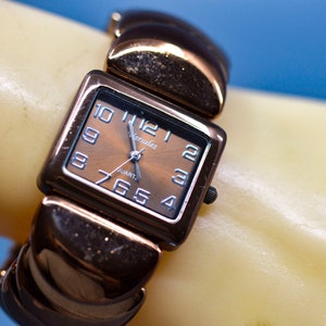 Copper tone, womens fashion watch on stretch bracelet