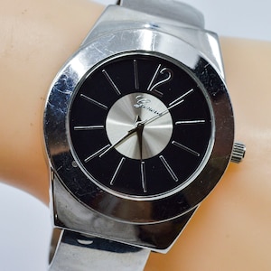 Large steel tone with black dial womens cuff watch