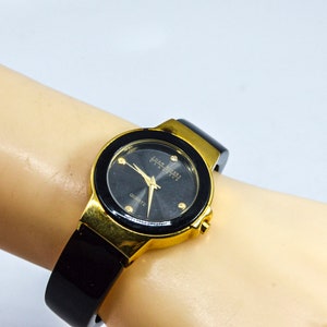 Black and gold tone womens cuff watch