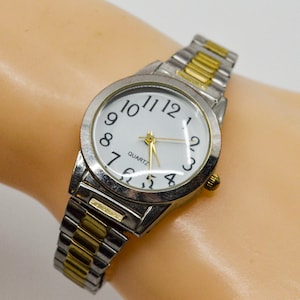 Steel tone with white dial and two tone stretch bracelet womens watch