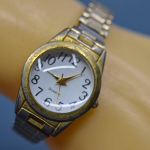 Gold and silver tone with white dial, stretch bracelet, womens watch