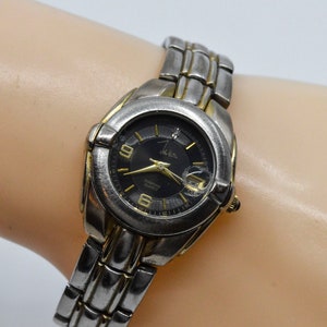 Steel tone with black dial womens sports watch