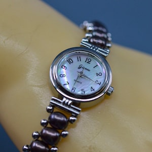 Silver tone, womens fashion watch on stretch bracelet