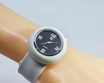 White tone with black dial with rubber stretch bracelet