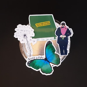 May include: Three stickers featuring a green chalkboard with the text "All of those moments are etched in my mind", a dandelion, and a blue and green butterfly with the text "Chasing butterflies".