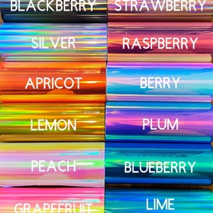 May include: A grid of twelve rectangular rolls of iridescent craft foil, each labeled with white text: Blackberry, Strawberry, Silver, Raspberry, Apricot, Berry, Lemon, Plum, Peach, Blueberry, Grapefruit, and Lime. The foils display metallic, color-shifting surfaces.