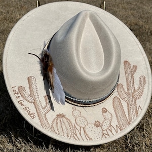 Custom hand burned wide brimmed cowgirl hat