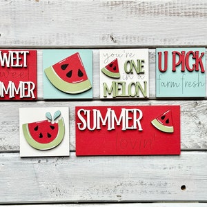 May include: Six wooden signs with watermelon designs and summer-themed text. The signs read "Sweet Sweet Summer", "You're One in a Melon", "U Pick Farm Fresh", "Summer Lovin'" and two signs with watermelon slices.