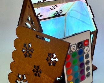 Christmas lighted cabin with battery operated led puck light.