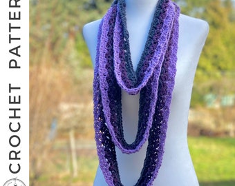 May include: A purple and gray crocheted infinity scarf. The scarf is made with a delicate stitch pattern and is long enough to be worn in multiple ways.