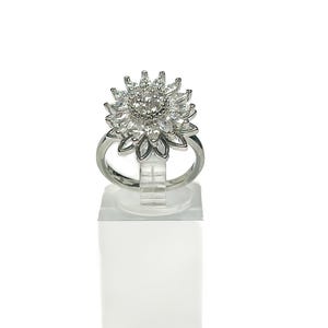 May include: A silver ring with a large, clear, flower-shaped design made of cubic zirconia stones.