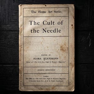 May include: A vintage book titled The Cult of the Needle from The Home Art Series, edited by Flora Klickmann. The off-white cover features black text, visible aging, and staining. It includes publication details for London and The Girl's Own Paper.