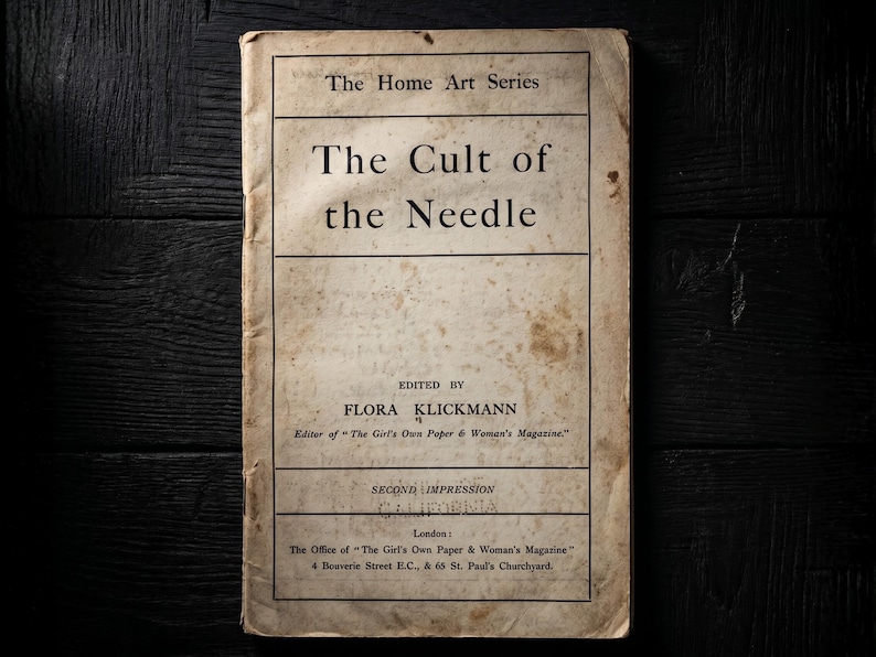 May include: A vintage book titled The Cult of the Needle from The Home Art Series, edited by Flora Klickmann. The off-white cover features black text, visible aging, and staining. It includes publication details for London and The Girl's Own Paper.