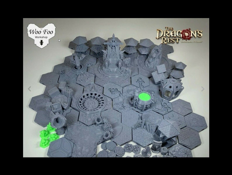May include: A set of 3D printed gray and green tabletop game pieces, including hexagonal tiles, buildings, and figures. The tiles feature intricate designs and the figures are detailed. The set is labeled "The Dragon's Rest - Crafted Printers".