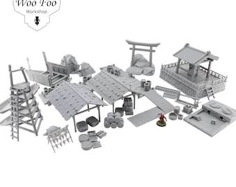 May include: A collection of unpainted miniature Japanese-style buildings and structures, including a torii gate, a well, and several buildings with tiled roofs. The set also includes barrels, a wooden bridge, and a ladder. The "Woo Foo Workshop" logo is in the upper left.