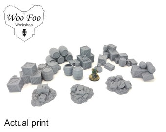 May include: A collection of 3D printed miniature props for tabletop gaming, including barrels, crates, and rubble. The props are gray and appear to be made of plastic.