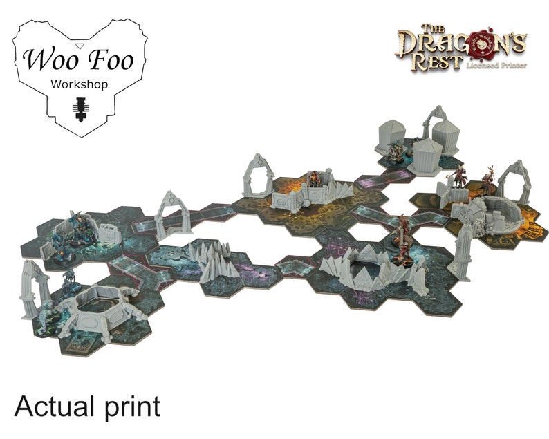 May include: A tabletop gaming terrain set featuring a modular, hexagonal tile design. The set includes various gray miniature structures, archways, and figures, with a detailed, multi-colored base. The text "Actual print" is visible.