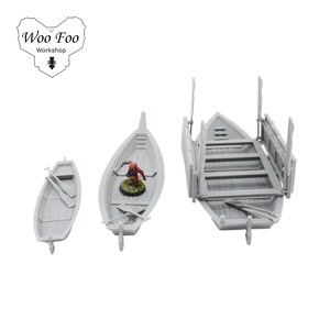 May include: Three grey miniature boats of varying sizes. The boats include oars and a small figure in one boat. The boats are designed for tabletop gaming or model building. The image includes the text "Woo Foo Workshop".