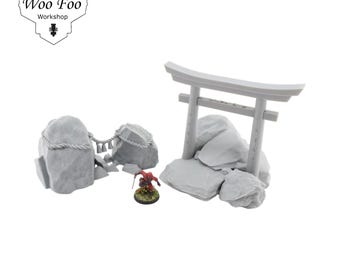 May include: A miniature gray stone Torii gate and rock formations with a small warrior figurine. The scene includes a rope and bell detail. The Woo Foo Workshop logo is in the upper left corner.
