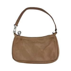 May include: A tan leather shoulder bag with a curved shape and a single handle. The bag has a zipper closure and a silver-tone metal clasp. The handle is attached with a silver-tone metal ring.