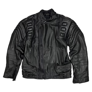 May include: Black leather motorcycle jacket with a quilted design on the shoulders and upper arms. The jacket features a zip-up front, multiple pockets, and a snap-closure collar. The sleeves have zippers at the cuffs and the waist has adjustable buckles.