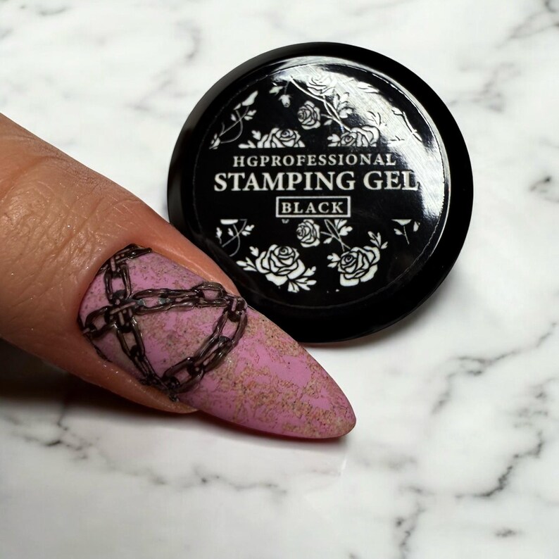May include: Black stamping gel for nail art. The jar has a black lid and a white label with the text "HGPROFESSIONAL STAMPING GEL BLACK" and a floral design.