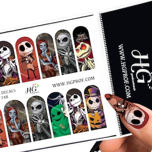 May include: A sheet of nail decals featuring various images of Jack Skellington and Sally from The Nightmare Before Christmas. The decals are printed on a white background and are ready to be applied to nails. The sheet also includes the website address www.hgprof.com.