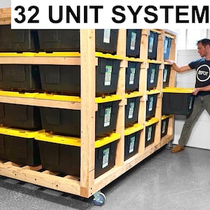 May include: A wooden storage system with 32 black storage bins on four shelves. The system is on wheels and has a "32 UNIT SYSTEM" sign at the top.