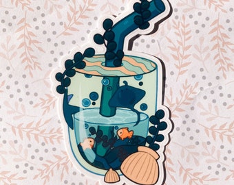 May include: A sticker of a clear glass with a blue and green striped lid, filled with water, seaweed, a seashell, and three fish. A blue straw with a green leafy top extends from the glass.