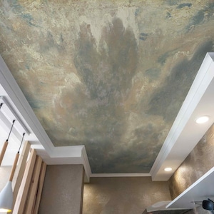 May include: An interior ceiling with a painted mural depicting a cloudy sky in shades of beige, gray, and blue. The ceiling is framed by white molding and includes recessed lighting and hanging pendant lights.
