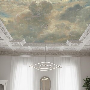 May include: A room ceiling with a painted sky mural, featuring clouds in shades of blue, gray, and beige. The ceiling has ornate white molding and a modern, abstract light fixture. White curtains frame a window.