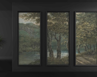 May include: Three framed landscape paintings depicting a forest scene with trees, a river, and a path. The paintings are in black frames and are hung on a dark gray wall.