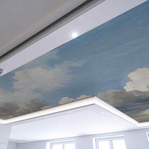 May include: A ceiling with a painted sky scene featuring blue sky and fluffy white clouds. The ceiling is framed by white trim and recessed lighting. Three pendant lights with wooden accents hang from the ceiling.