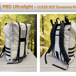 May include: A white PBD Ultralight ULK35 DCF Dyneema Pack backpack with black straps and a white background. The backpack is shown from two different angles.