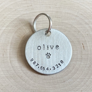 a simple personalized dog id tag for collar with name and phone number symbol hand stamped lightweight aluminum round 1" lost pet cat tag