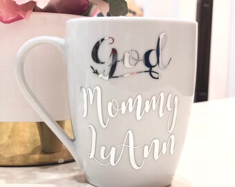 May include: White ceramic mug with a silver vinyl design that reads "God Mommy LuAnn".