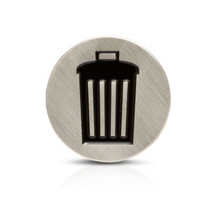May include: A silver round button with a black trash can icon.