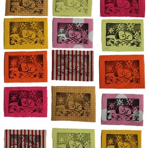 May include: A selection of small, square fabric patches with a sleeping dog design. The patches are in various colours, including pink, yellow, orange, and green, with a black and white dog illustration. Some have striped or polka dot backgrounds.