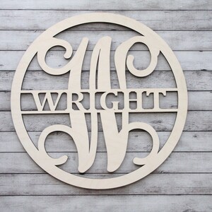 May include: A wooden round sign with a decorative initial "W" and the last name "WRIGHT" cut out. The sign is unfinished and ready to be painted.