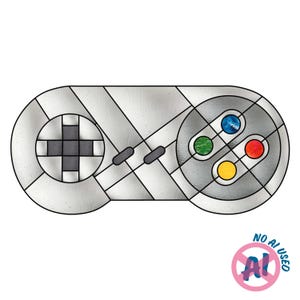 May include: A stained glass panel shaped like a video game controller with a silver-grey frame. It features a dark grey directional pad on the left and four circular buttons in blue, green, red, and yellow on the right, all connected by black lead lines.